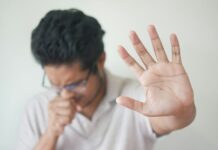 최신 의학적 접근을 통한 알레르기 증상 완화 a man holding his hand up in front of his face