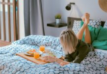 일상에서 실천 가능한 스트레스 해소법 woman lying on bed white holding board