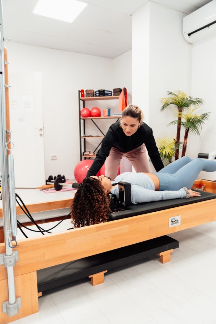 a couple of women are doing exercises in a gym
