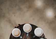 건강을 위해 피해야 할 나쁜 습관 flat lay photography of eight coffee latte in mugs on round table