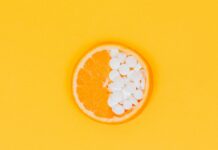 면역력 향상을 위한 비타민과 미네랄 섭취 orange fruit slices on yellow surface