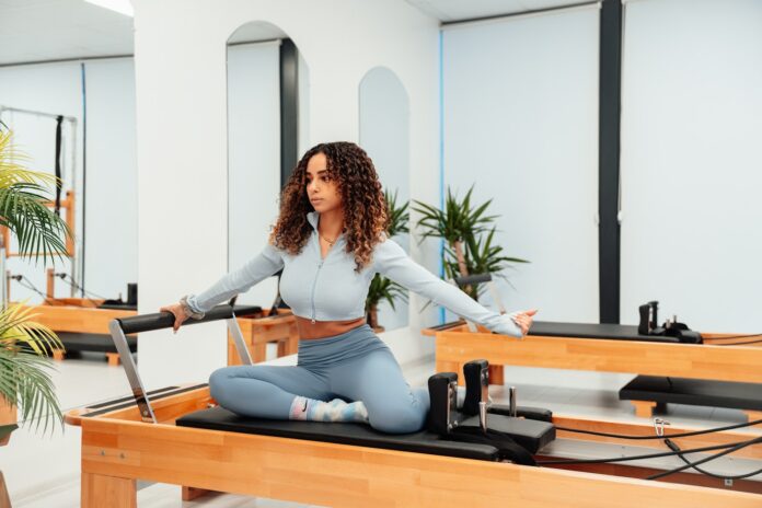 a woman sitting on a piyor in a room